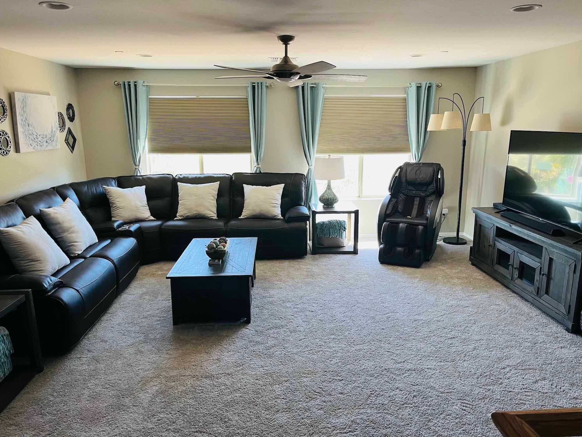Sectional couch, chair and TV in living area for relaxing with fellow inpatient gambling addiction treatment residents