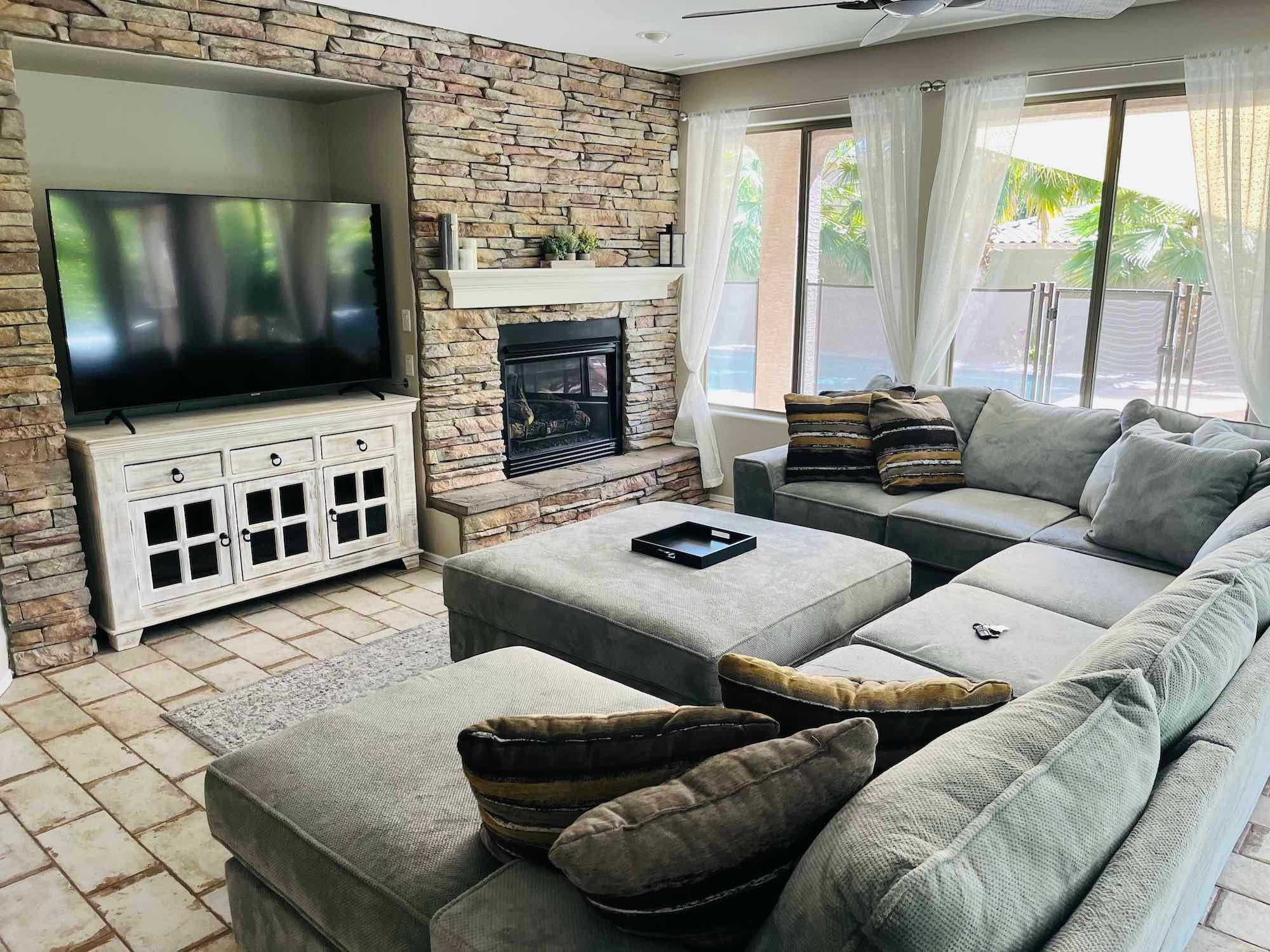 Living room with sectional couch and television for people in gambling recovery treatment in Goodyear, Arizona