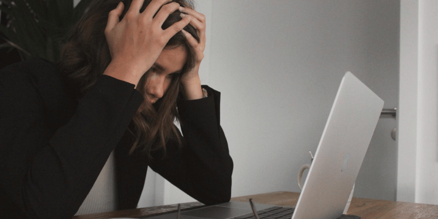 woman stressed while on laptop