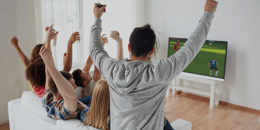 friends watching soccer game on TV