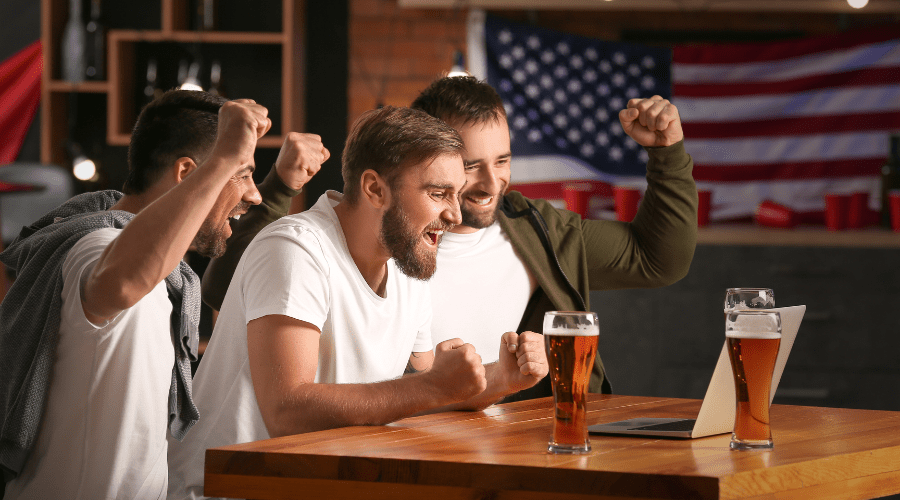 3 guys at a bar betting on sports