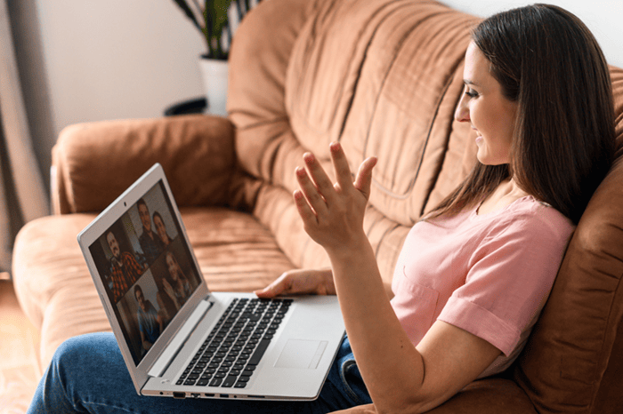 woman waving to friends over Zoom