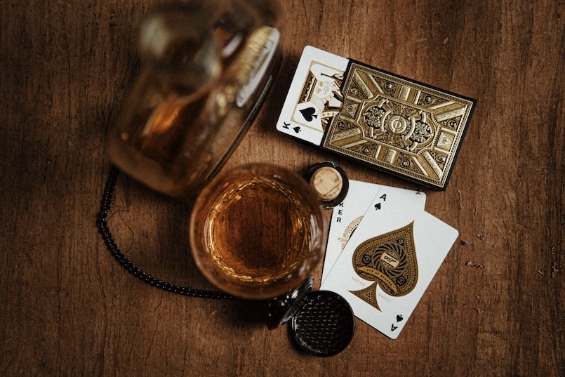 Gambling cards and alcohol on table