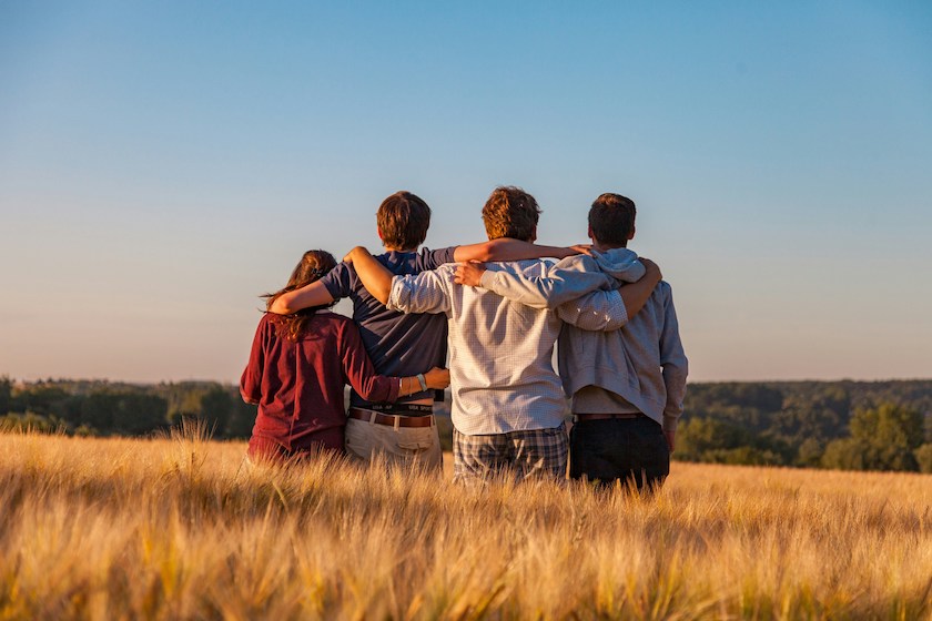 Group of 4 friends in a field