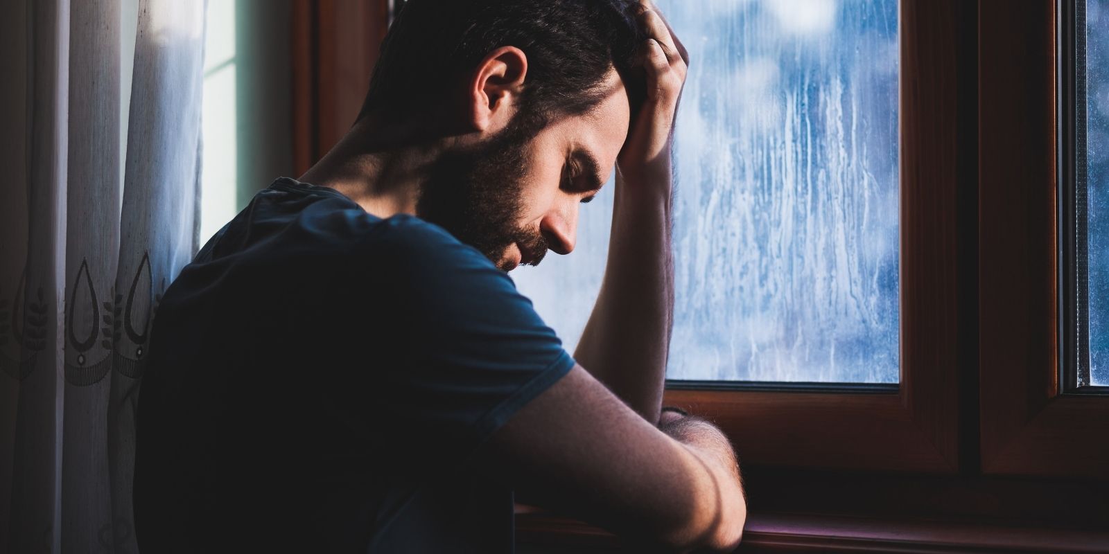 man feeling guilty with head in hands