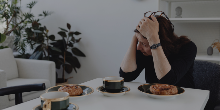 woman distressed at kitchen table