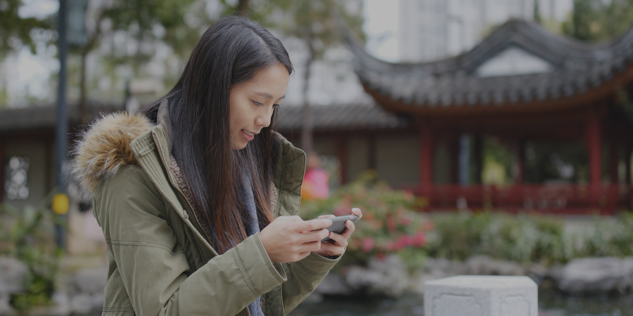 woman playing game on phone