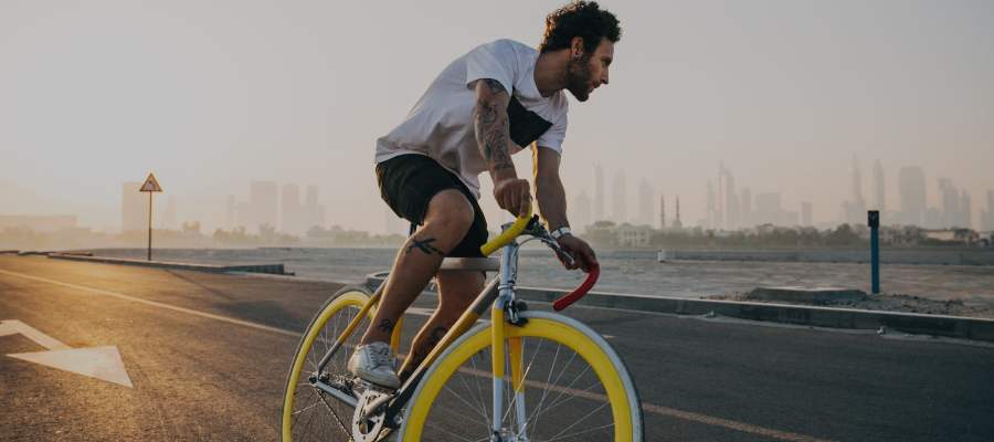 man riding bike along the water