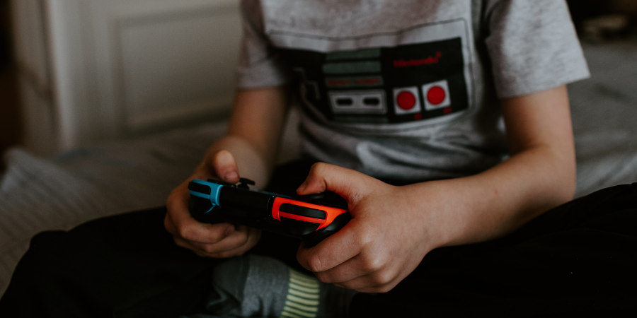 kid holding video game controller