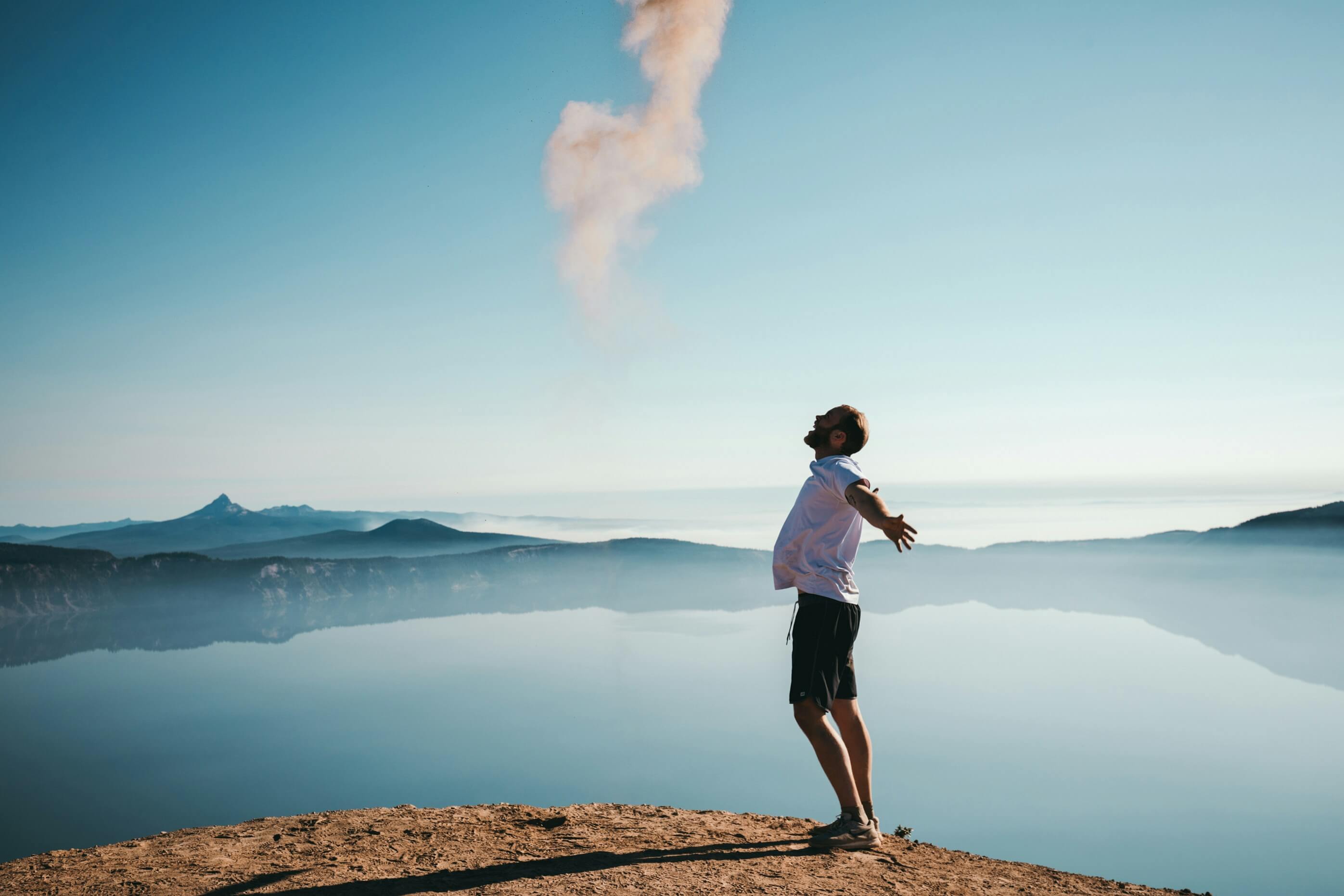 Happy man on mountain at lake