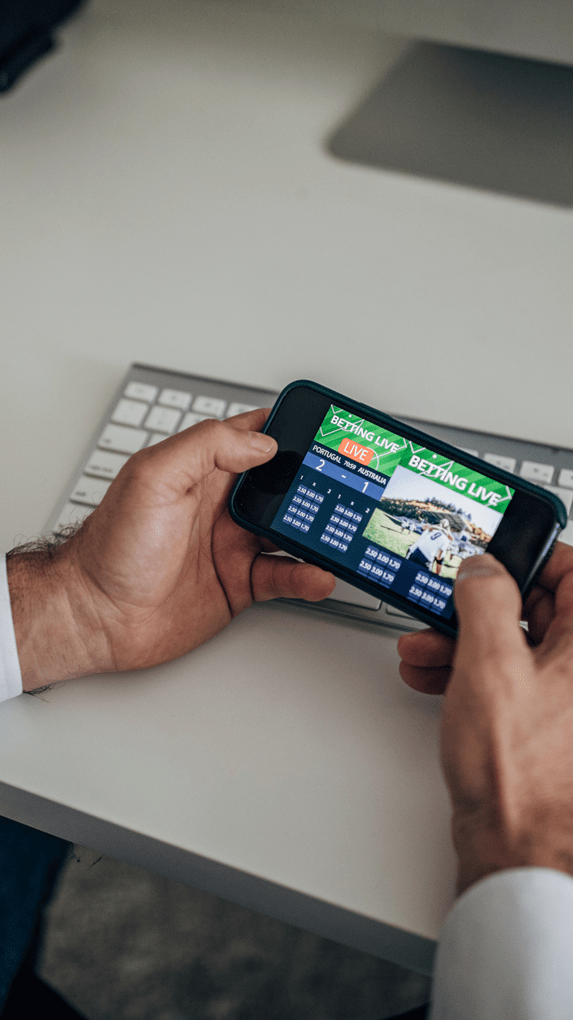 man sport betting on phone